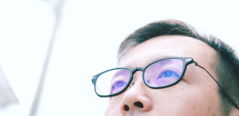 man wearing blue light glasses