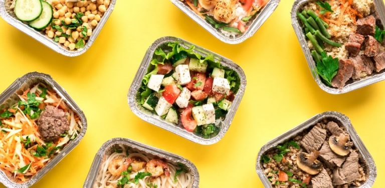 Boxes of prepared meals on a yellow background