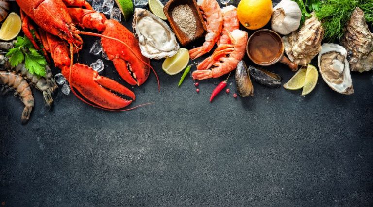 A variety of seafood on a chalkboard background.